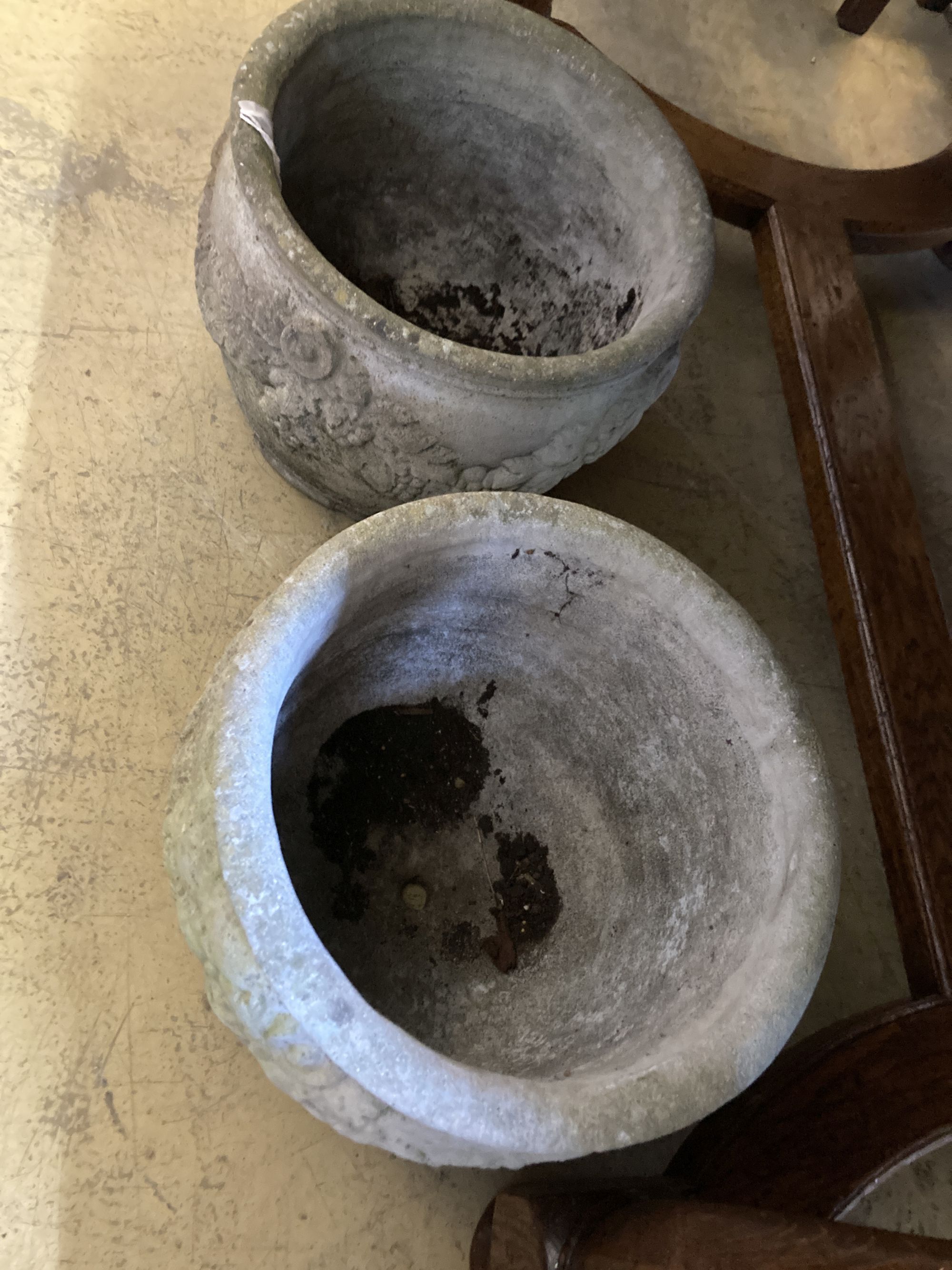 A pair of reconstituted stone circular garden planters, diameter 36cm, height 26cm